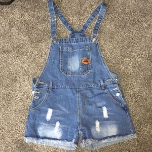 Medium wash, distressed Denim cut-off overalls